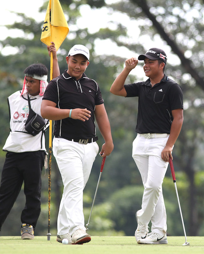 Paolo Wong (left) and teammate Ira Alido react after the former missed an eagle-putt on No. 4.