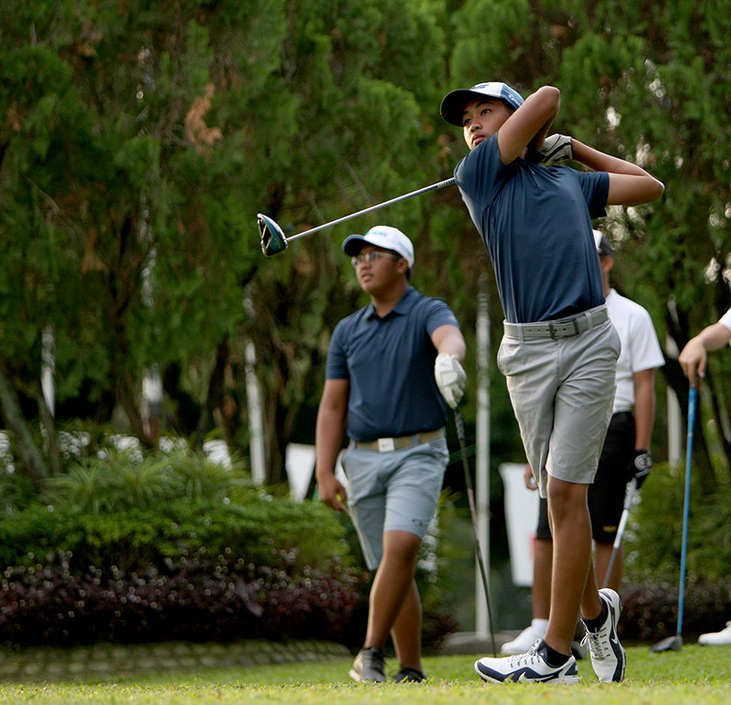 Jet Hernandez unleashes his drive on No. 1 as teammate Josh Jorge looks on