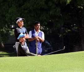 aidric chan fires in bunker in hole 4 while ira alido  watching