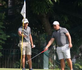 alido and wong examine the green in hole 5