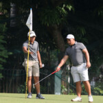 alido and wong examine the green in hole 5