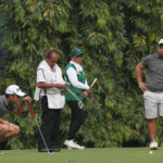 alido study his line in hole 3 with his partner wong waiting