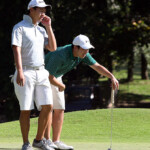 jobim carlos(left) and inigo raymundo study his line in  hole 5 green