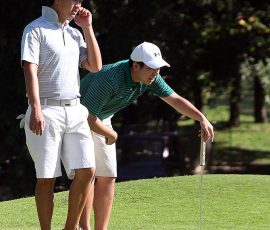 jobim carlos(left) and inigo raymundo study his line in  hole 5 green